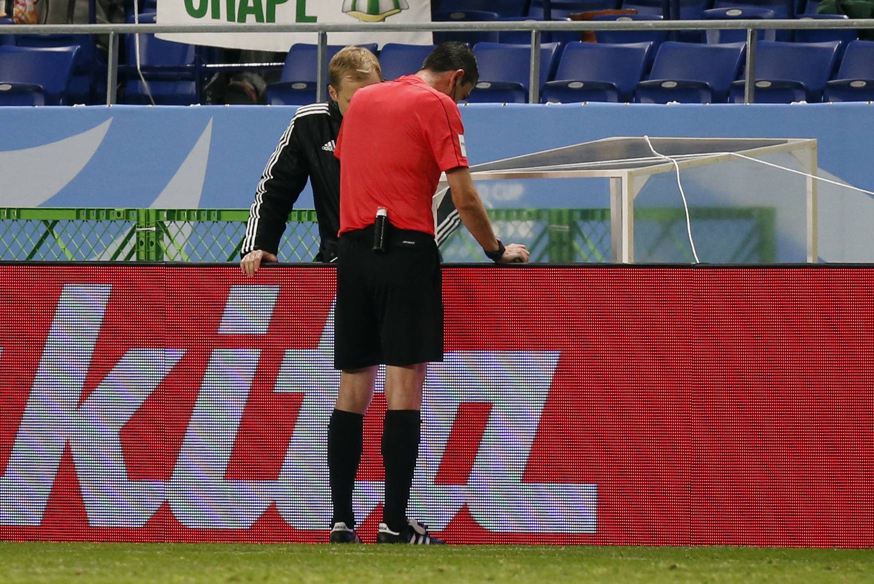Referee Viktor Kassai references a video replay before his decision to award a penalty