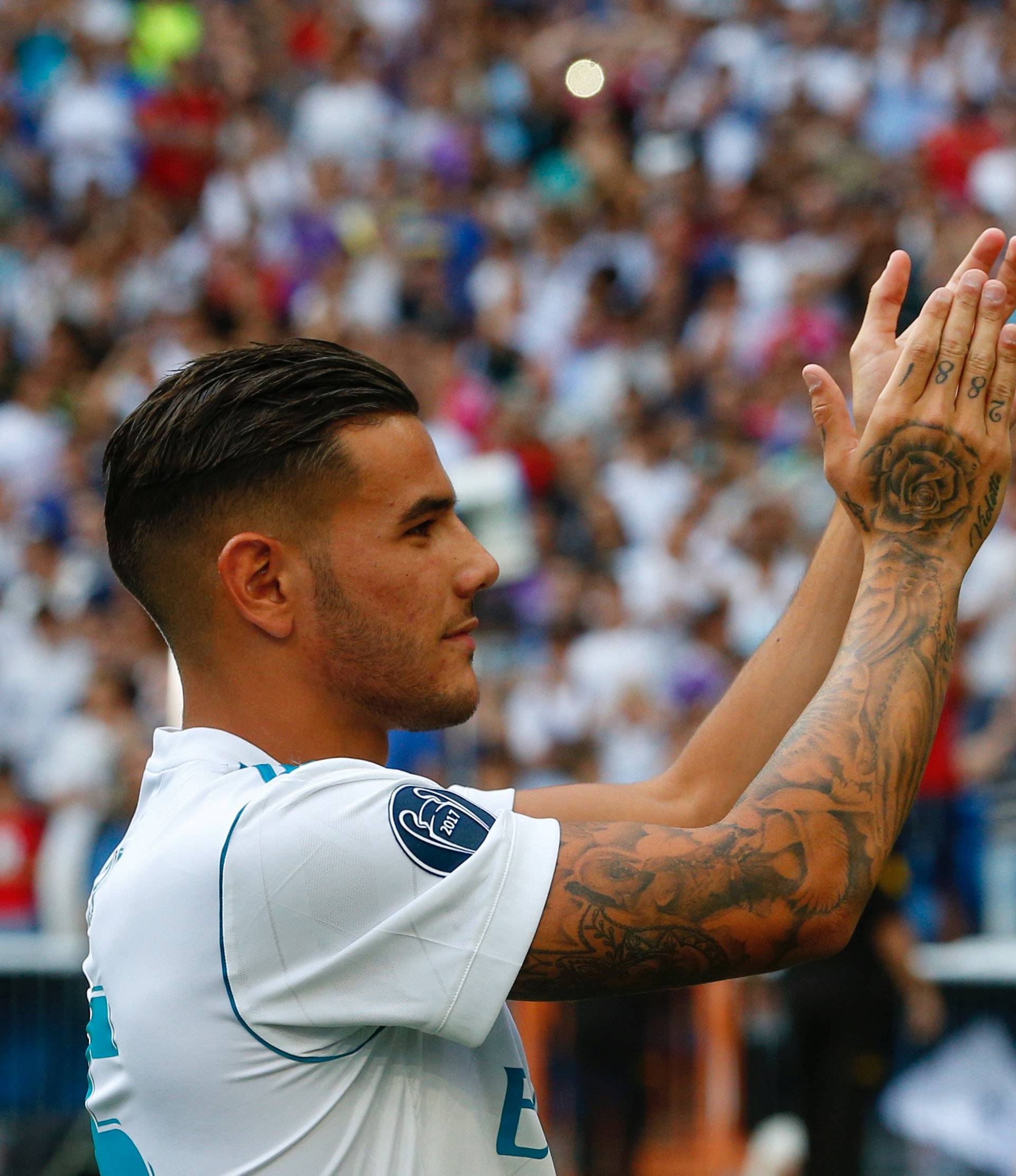 Real Madrid's new player Theo Hernandez acknowledges supporters during his presentation at the Santiago Bernabeu Stadium in Madrid