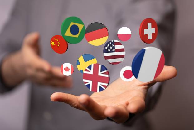 3D rendered stickers of different countries hovering over a person's hand