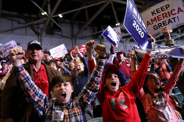 Young supporters cheer as U.S. President Donald Trump speaks during a campaign rally in Tupelo, Mississippi