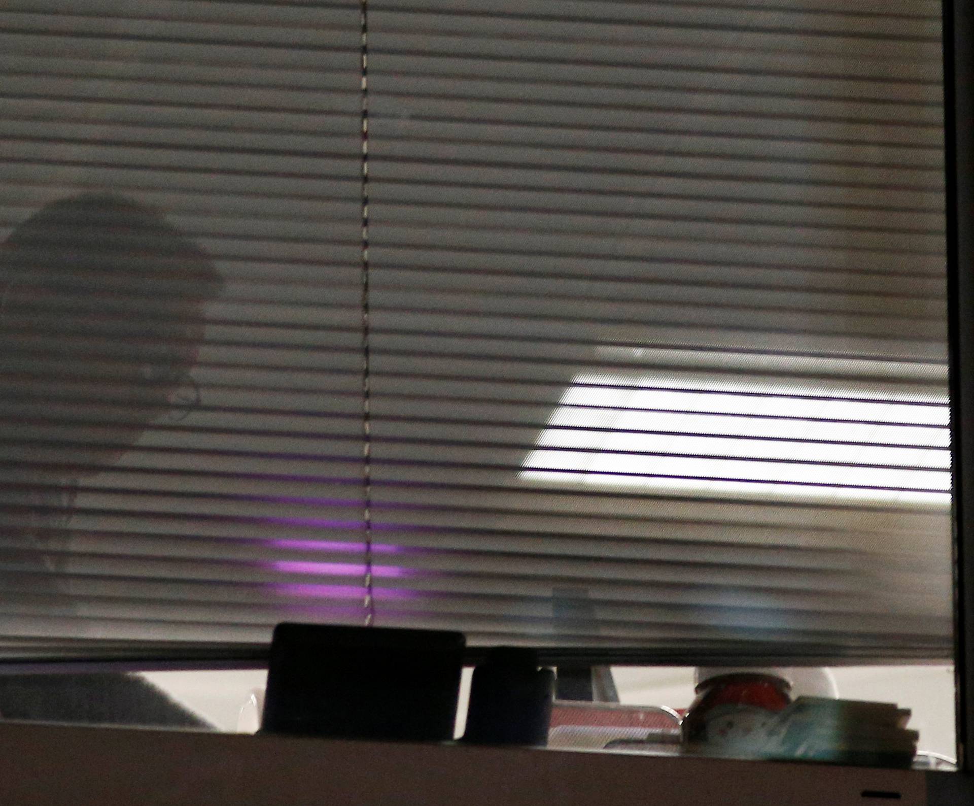 A person is seen inside the building which houses the offices of Cambridge Analytica as investigators from Britain's Information Commissioners Office entered, following the granting of a search warrant by a High Court judge, in London