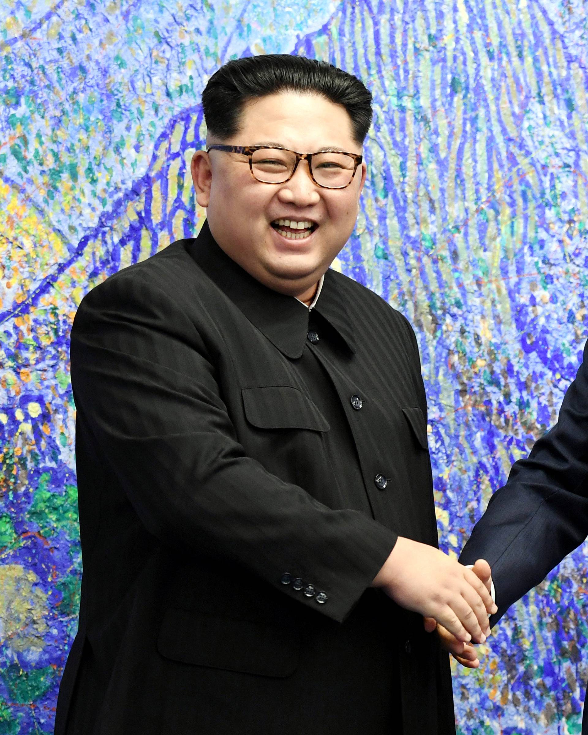 South Korean President Moon Jae-in shakes hands with North Korean leader Kim Jong Un during their meeting at the Peace House