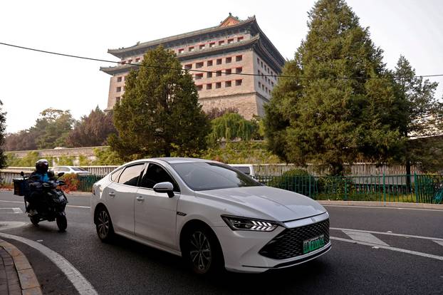 FILE PHOTO: FILE PHOTO: BYD's electric vehicle (EV) Qin moves on a street in Beijing