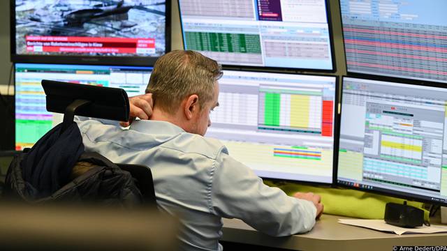 A stock trader watches his monitors on the floor of the Frankfurt Stock Exchange. The Russian attack on Ukraine sent stock markets around the world into a tailspin.