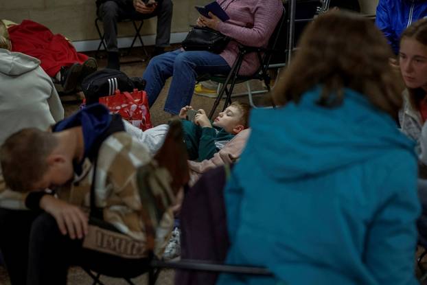 People take shelter inside a metro station during Russian missile and drone attacks in Kyiv