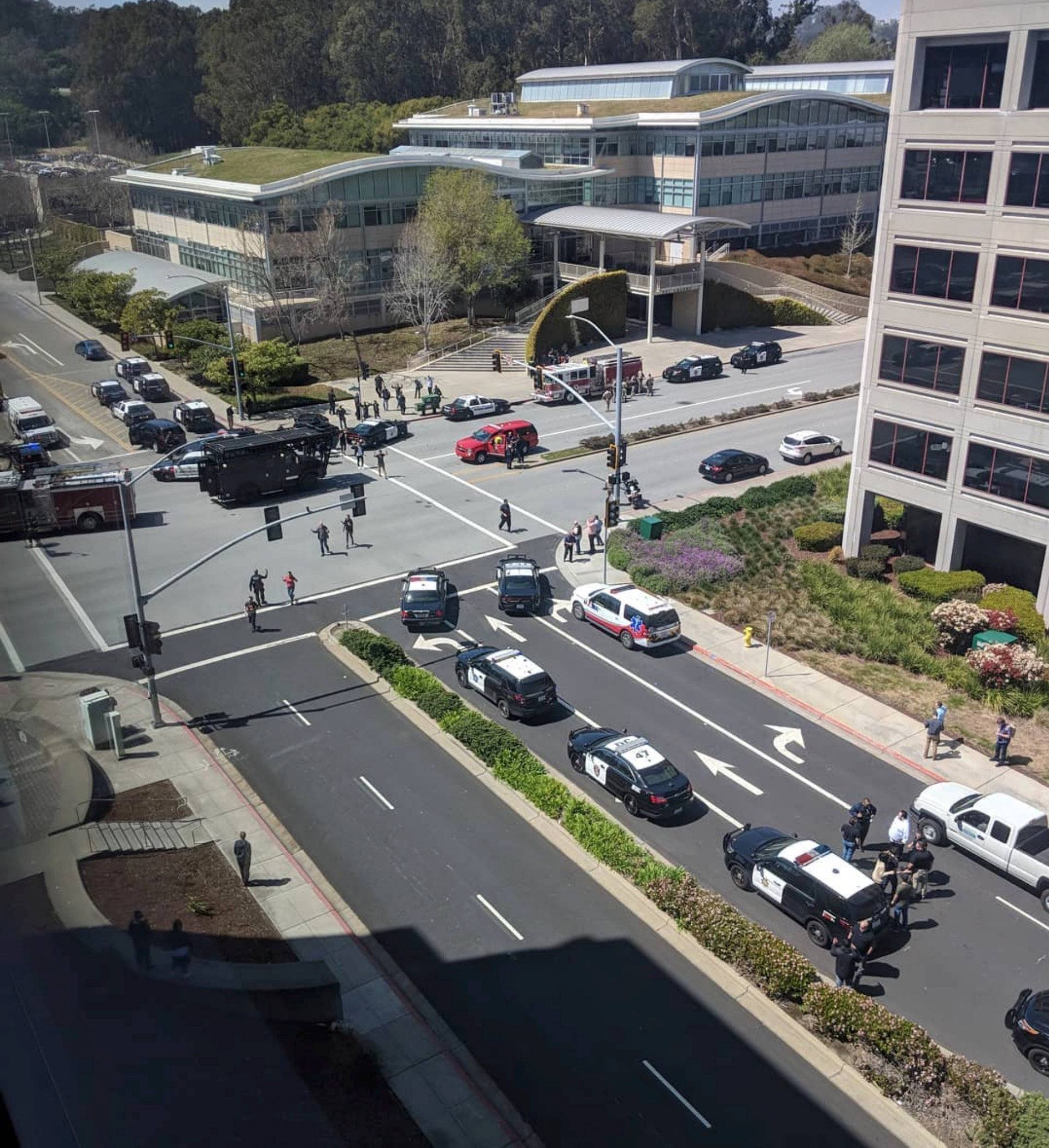 Officials are seen following a possible shooting at the headquarters of YouTube, in San Bruno