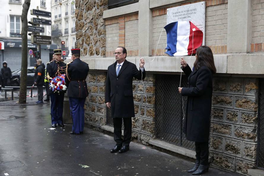 French President Francois Hollande and Paris Mayor Anne Hidalgo unveil a commemorative plaque next to the "La Belle Equipe" bar and restaurant in Paris