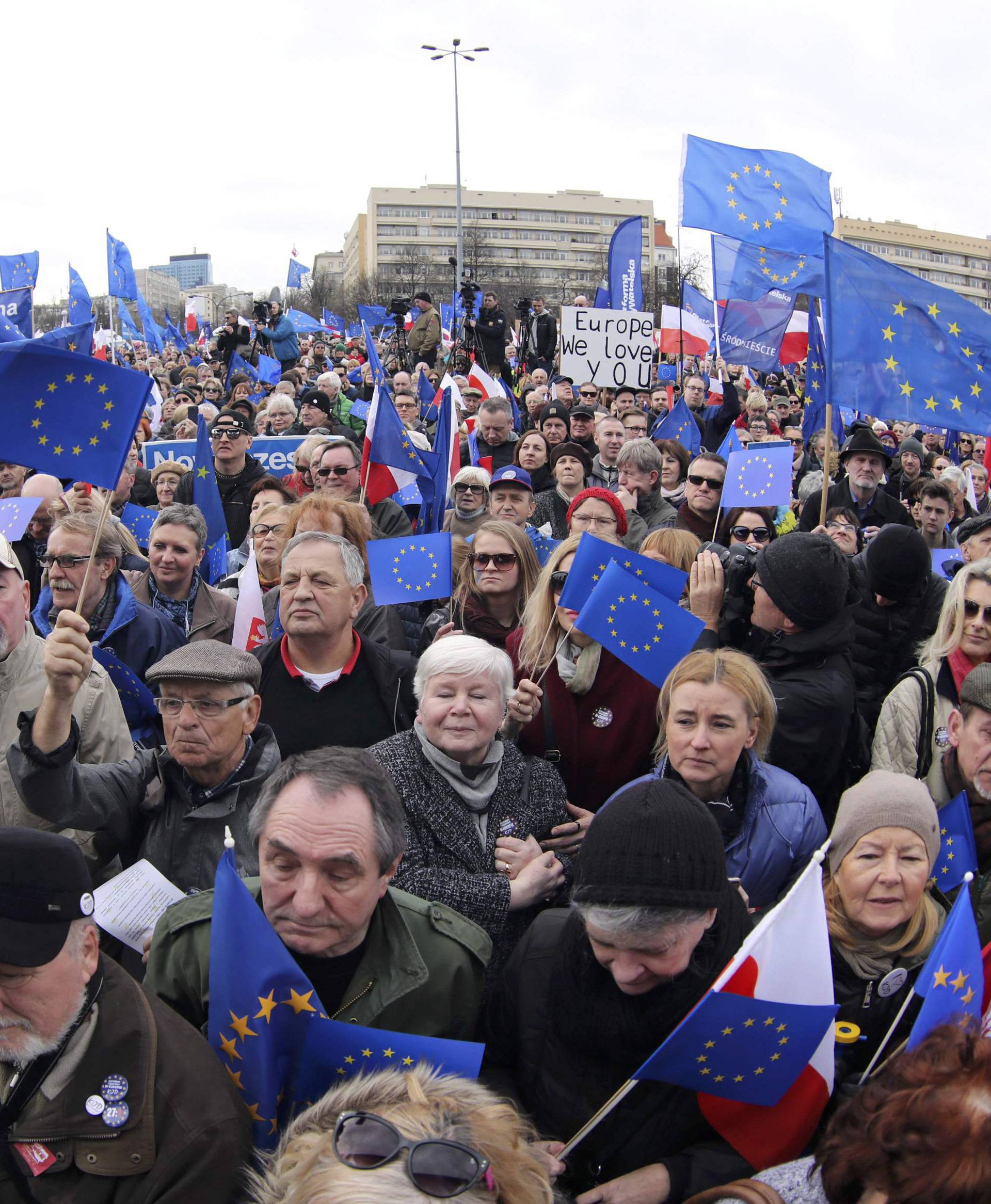People hold EU flags as they attend a march called 'I love Europe' to celebrate the 60th anniversary of the Treaty of Rome in Warsaw