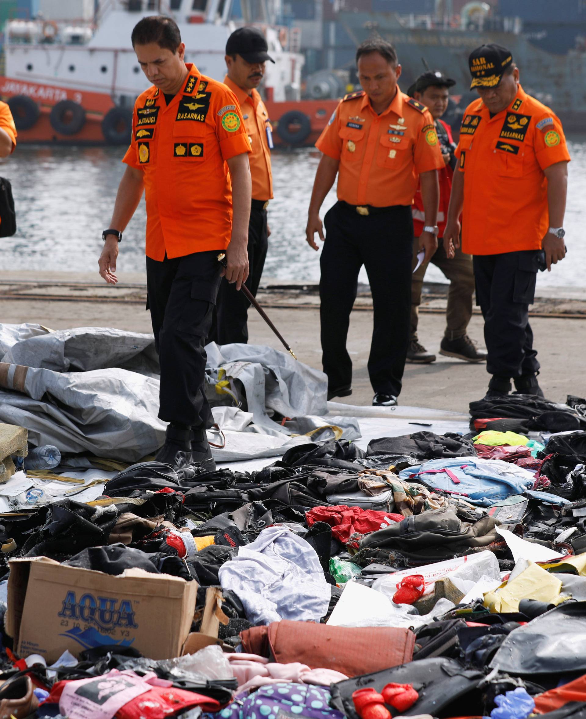 Chief of Indonesia's Lion Air flight JT610 search and rescue operations Muhammad Syaugi looks through recovered belongings believed to be from the crashed flight at Tanjung Priok port in Jakarta