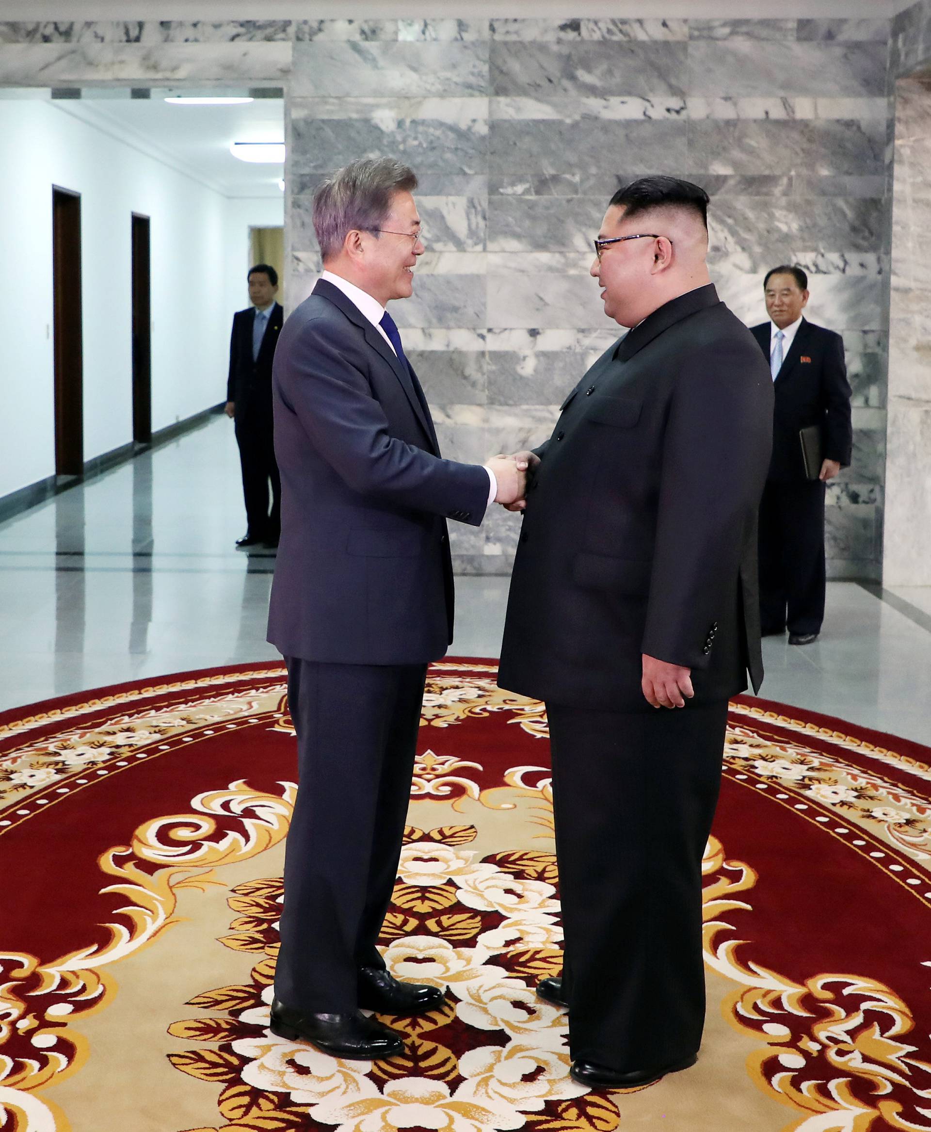South Korean President Moon Jae-in shakes hands with North Korean leader Kim Jong Un during their summit at the truce village of Panmunjom