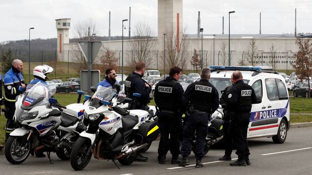 French police take position outside the prison where an inmate in one of France's most secure prisons stabbed two guards with a knife in Conde-sur-Sarthe