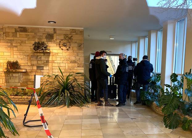 Police wait inside a building of the Heidelberg university