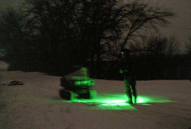 Ukrainian servicemen operate an unmanned ground vehicle fit for delivery missions on the frontline in Donetsk region