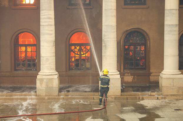 Firefighters battle flames as the library at the University of Cape Town burns, in Cape Town