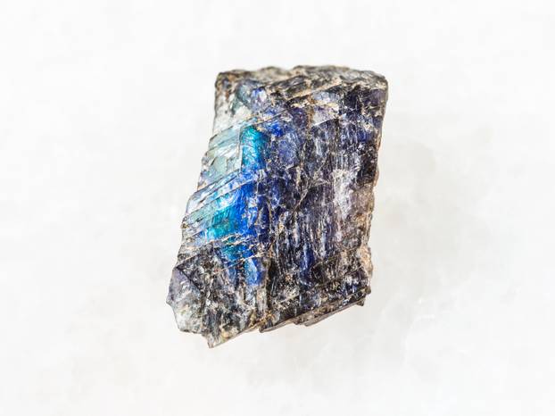 raw labradorite stone on white marble