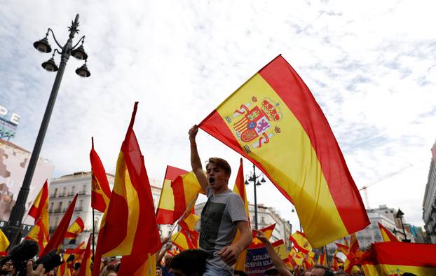 Demonstrators wave Spanish flags during a demonstration in favor of a unified Spain on the day of a banned independence referendum in Catalonia, in Madrid