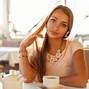 Beautiful young woman in a cafe drinking tea