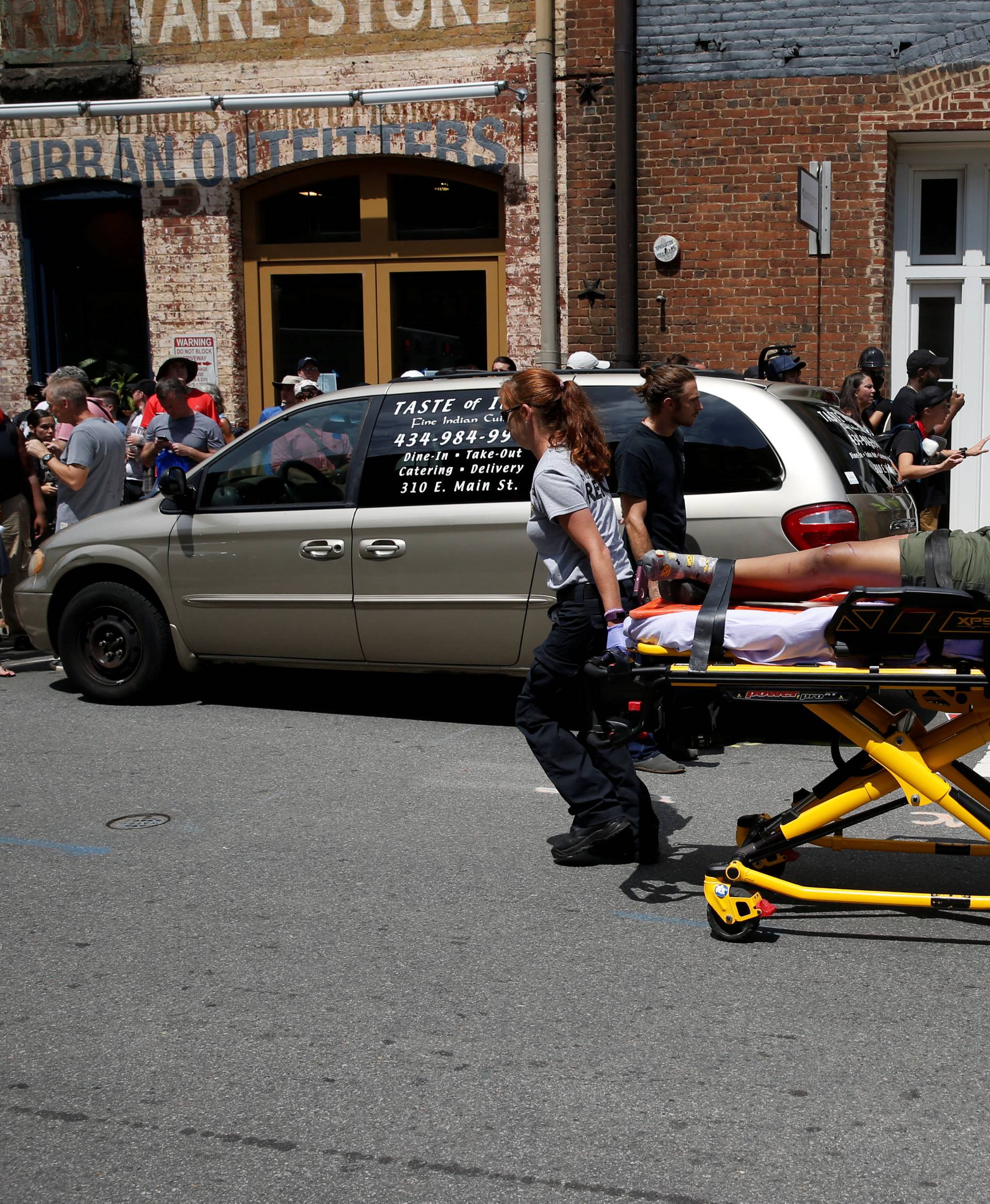 Rescue workers transport a victim who was injured when a car drove through a group of counter protestors at the "Unite the Right" rally Charlottesville