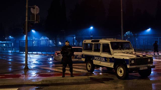 Police guard the entrance to the United States embassy building in Podgorica