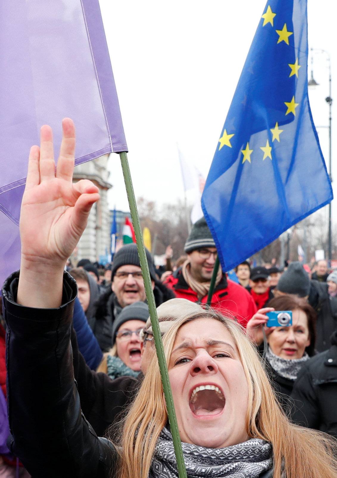 People take part in a protest against a proposed new labor law, billed as the "slave law", in Budapest