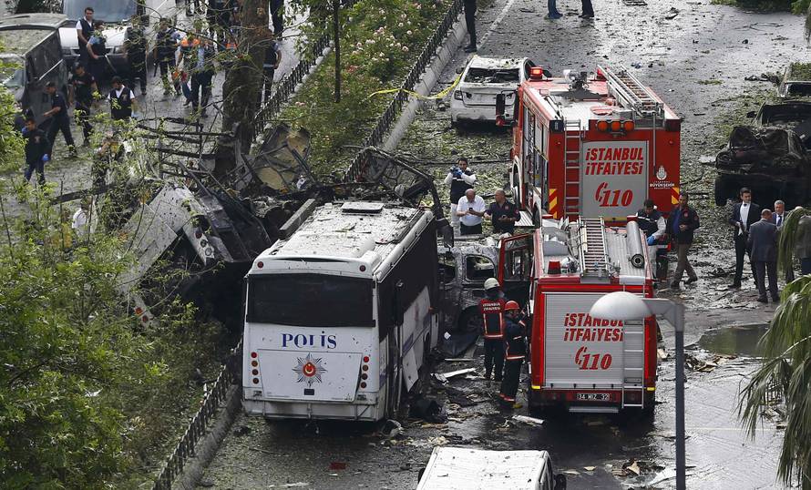 Fire engines stand beside a Turkish police bus which was targeted in a bomb attack in a central Istanbul district