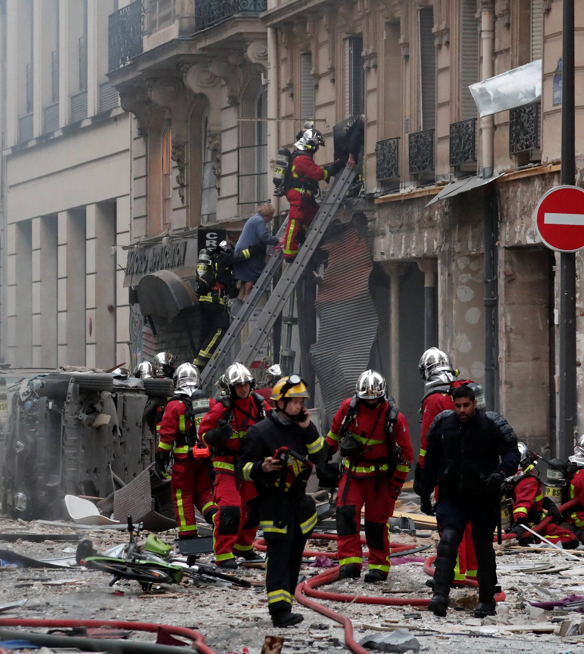 Firemen work at the site of an explosion in a bakery shop in the 9th District in Paris