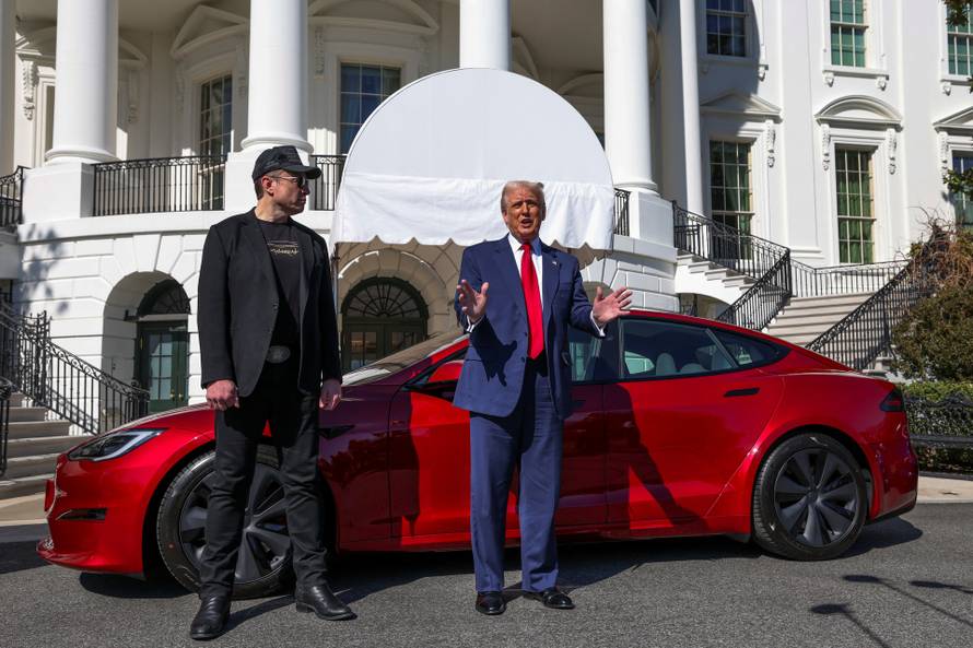 U.S. President Donald Trump views a Tesla car at the White House in Washington