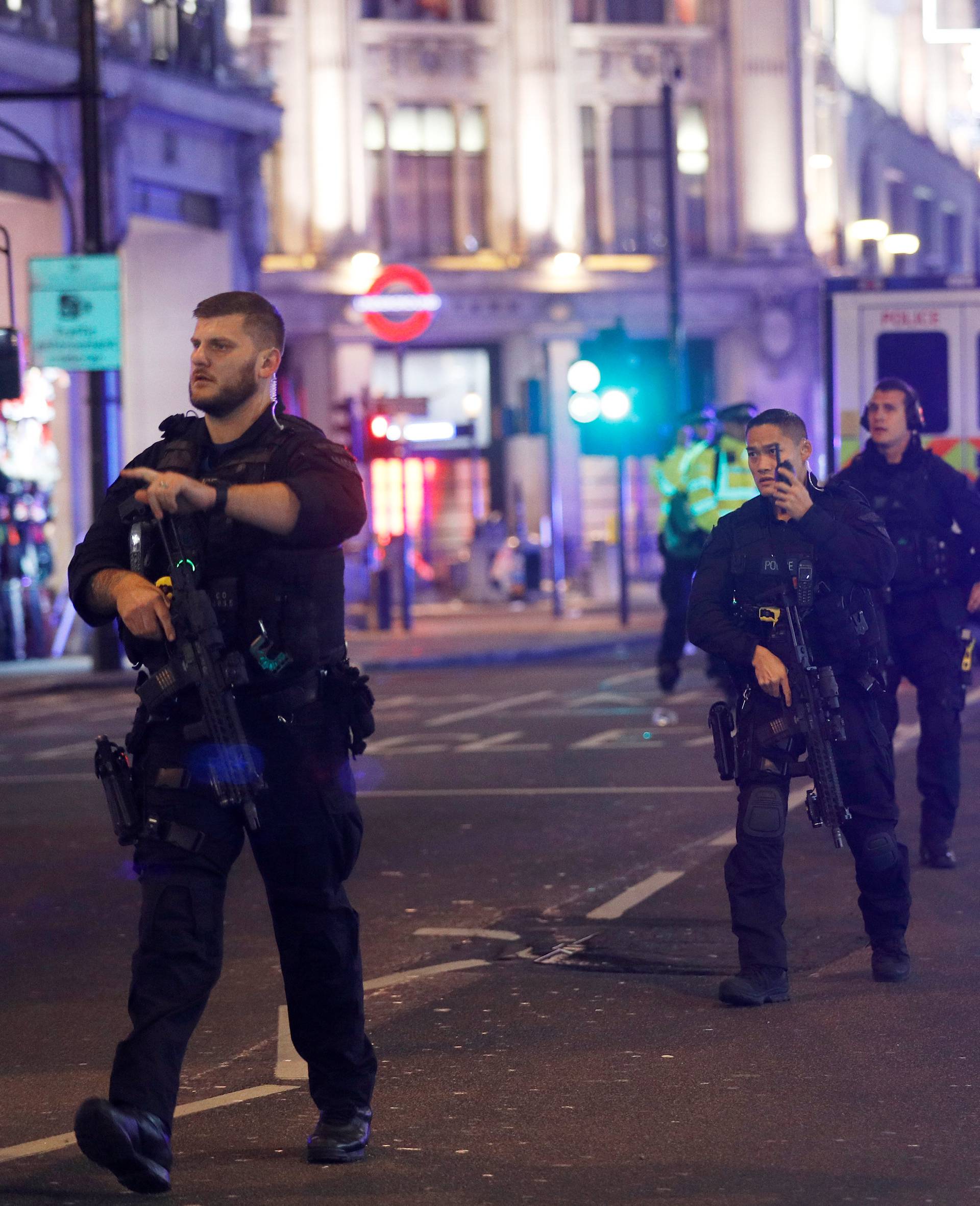 Armed police walk along Oxford Street, London