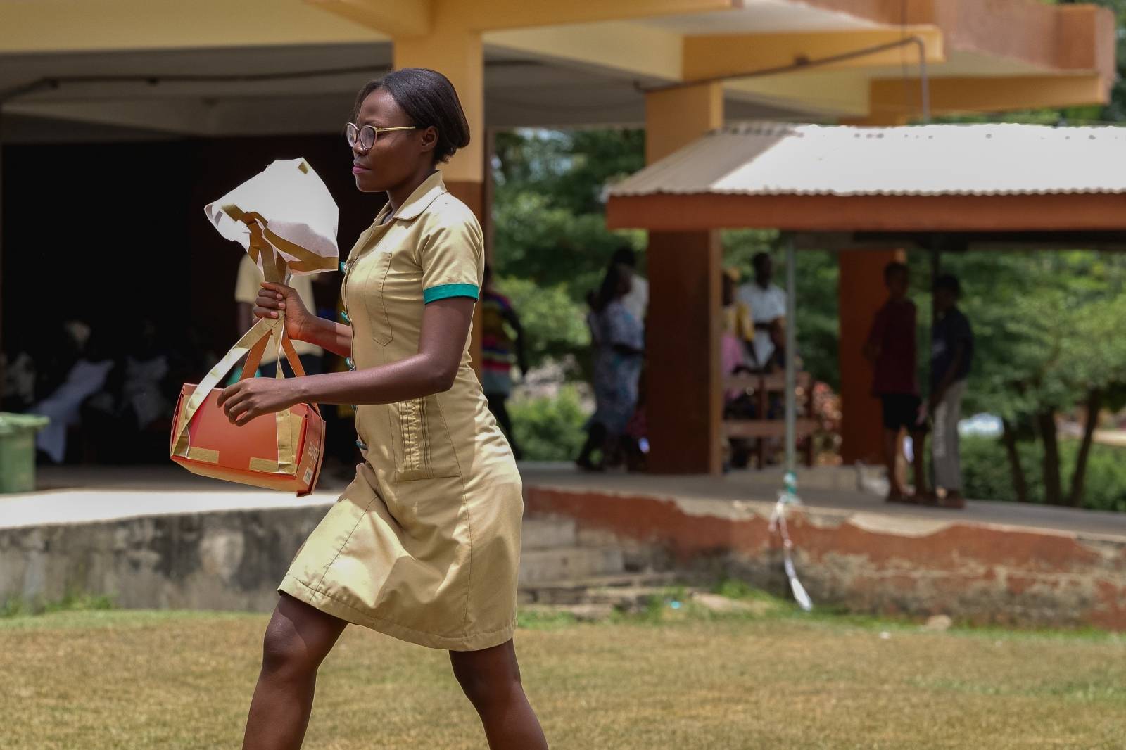 A nurse carries a Zipline vaccine delivery in Ghana