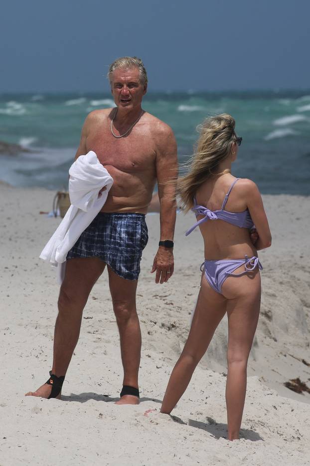 EXCLUSIVE: Dolph Lundgren, 67, is seen with his 29-year-old bikini-clad wife as they hit the beach in Miami