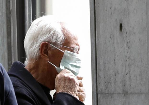 Designer Giorgio Armani puts on a face mask as he arrives at the venue of his Autumn/Winter 2020 collection fashion show during Milan Fashion Week in Milan
