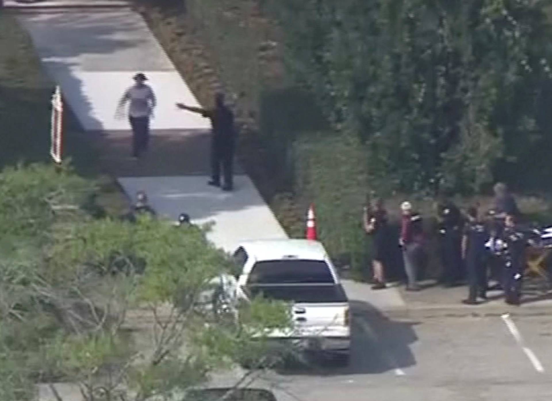 Police evacuate people from a building as a stretcher stands by following a shooting incident at the municipal center in Virginia Beach