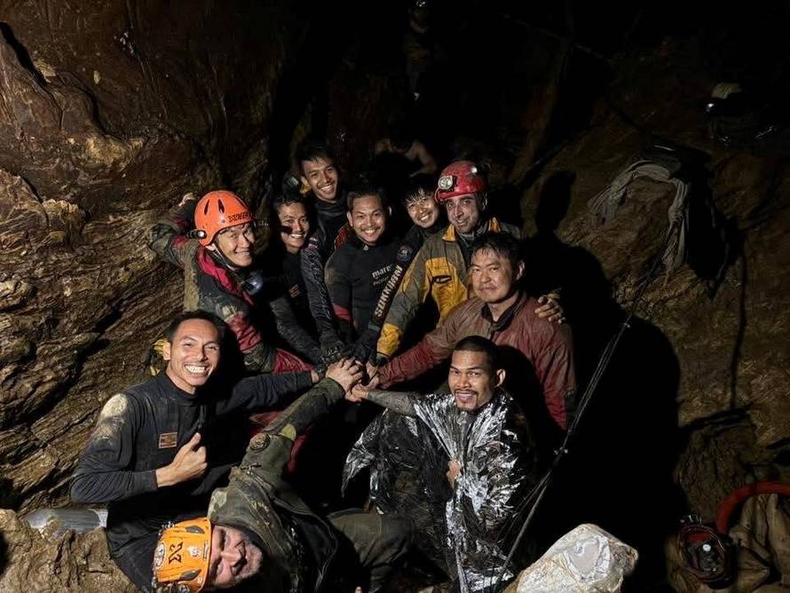 Rescuers bring out a person who was trapped in the cave in Xaisomboun Province