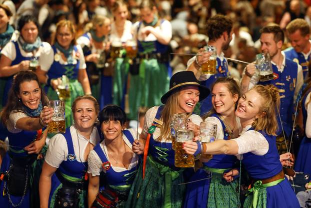 Oktoberfest waitresses toast with beer while they celebrate the end of the 189th Oktoberfest in Munich