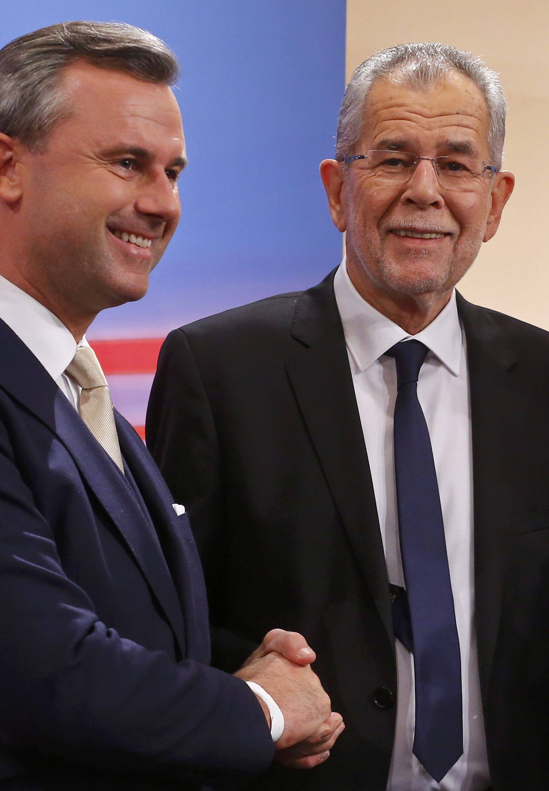 Austrian far-right Freedom Party (FPOe) presidential candidate Hofer and his rival Van der Bellen, who is supported by the Greens, react during a TV show in Vienna