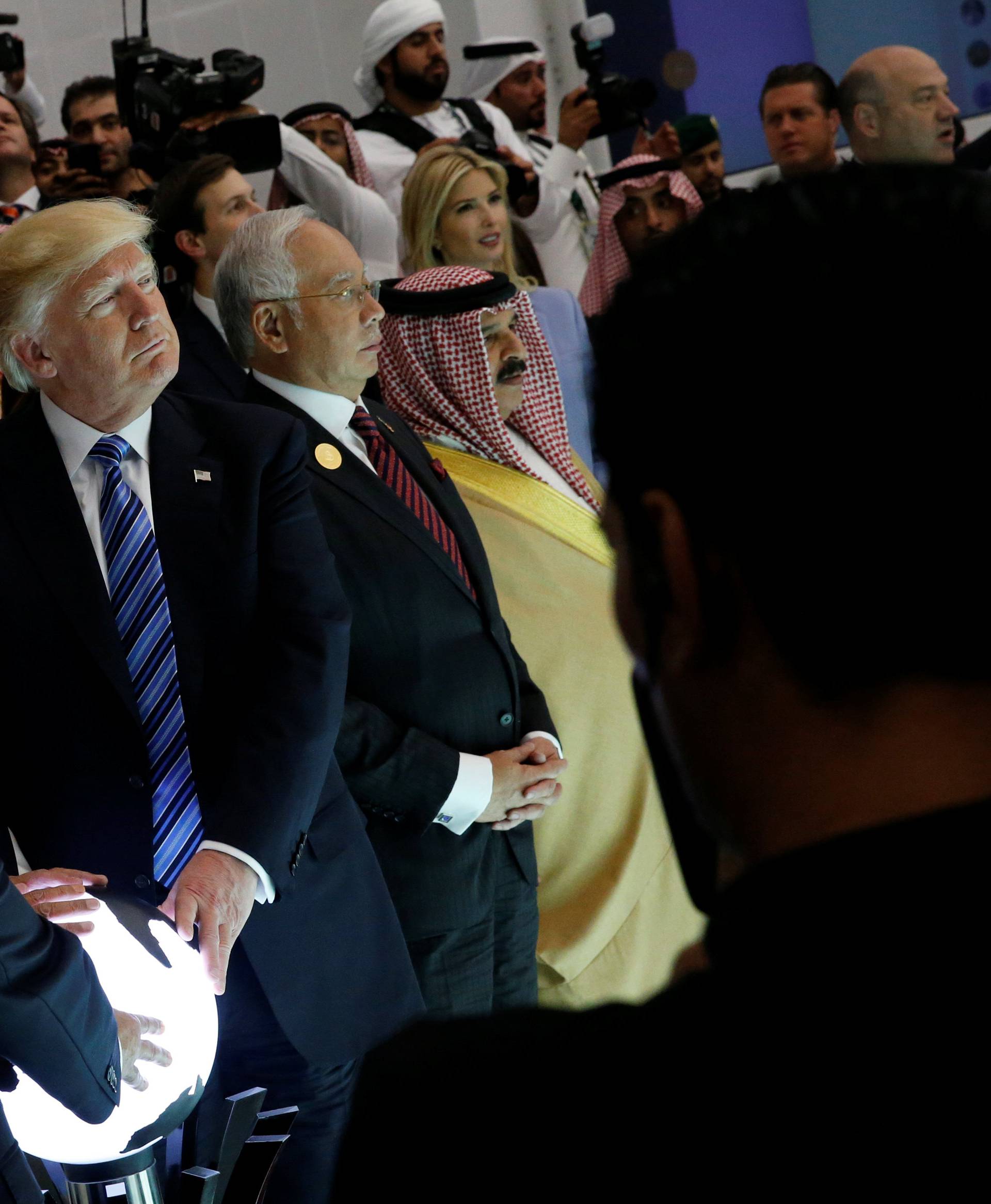 Trump and other leaders react to a wall of computer screens coming online as they tour the Global Center for Combatting Extremist Ideology in Riyadh