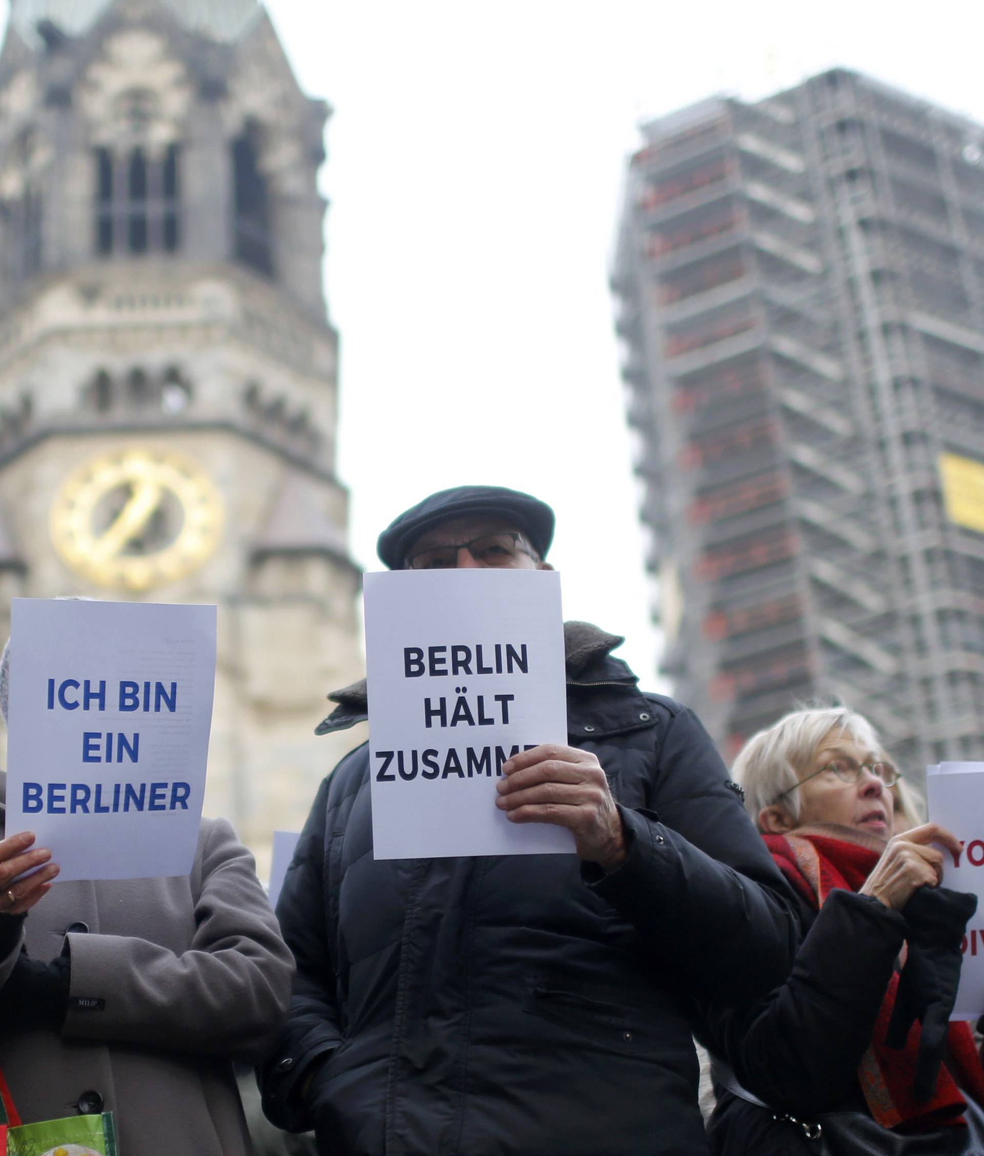 Berliners and refugees gather to sing "We Are The World" in front of the Kaiser Wilhelm Gedaechtniskirche in Berlin