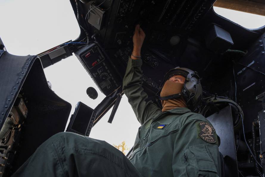 Ukrainian military pilot prepares for a flight inside a Mi-8 helicopter, in Easter Ukraine