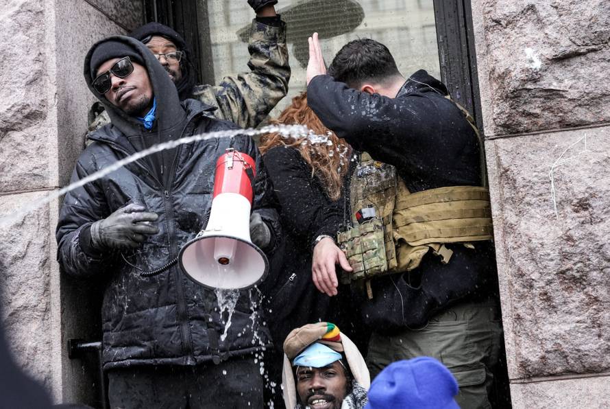 People attend the "March Against Minnesota Fraud" in Minneapolis