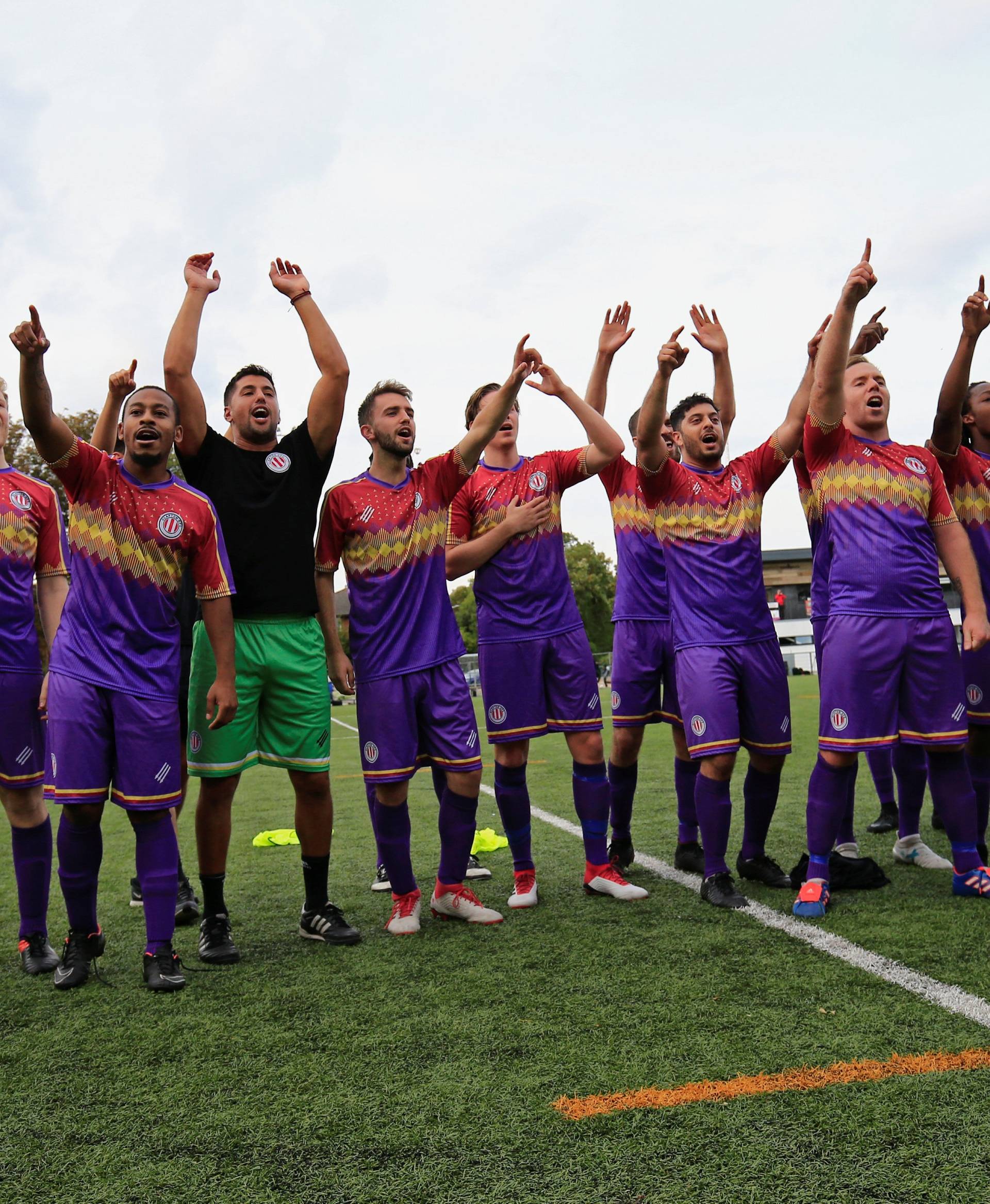 Clapton CFC players celebrate their win against Healing Town in East Acton, in London