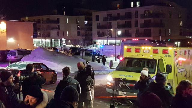 An ambulance is parked at the scene of a fatal shooting at the Quebec Islamic Cultural Centre in Quebec City