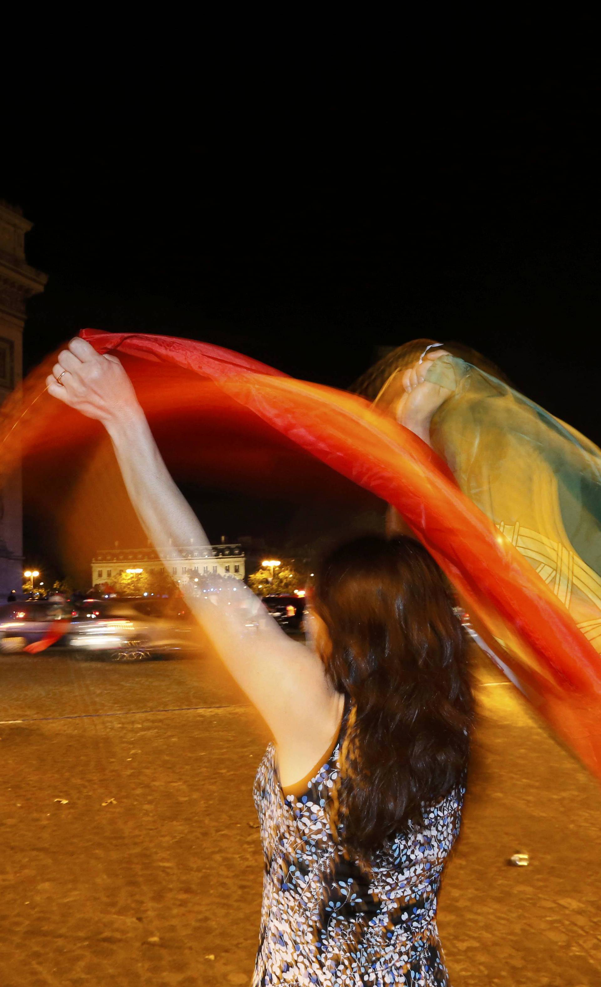 A Portugal fan reacts on the Champs-Elysees after the team won the EURO 2016 final soccer match       