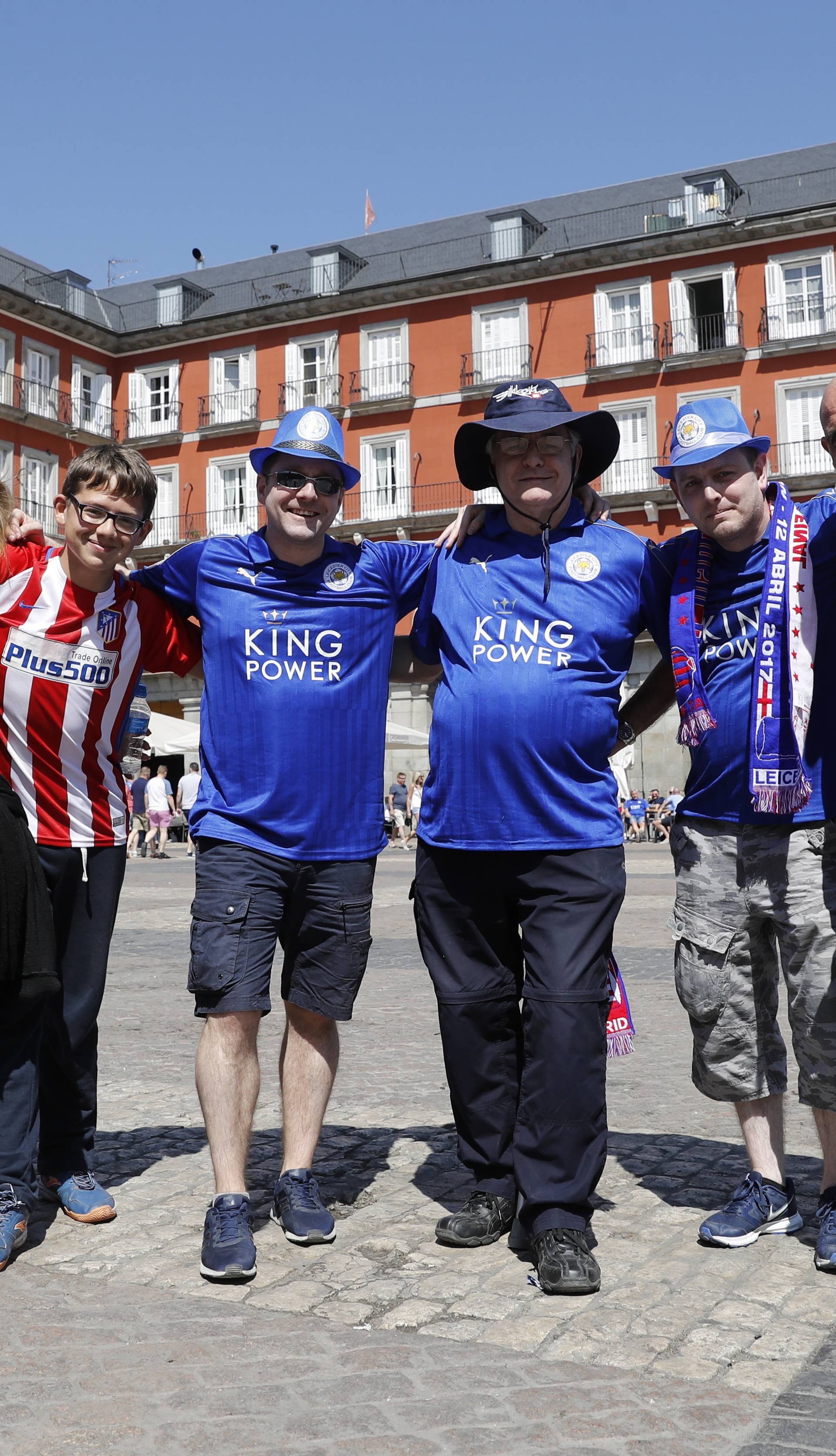 Atletico Madrid fans and Leicester fans pose for a photo as they meet in the Plaza Mayor before the match