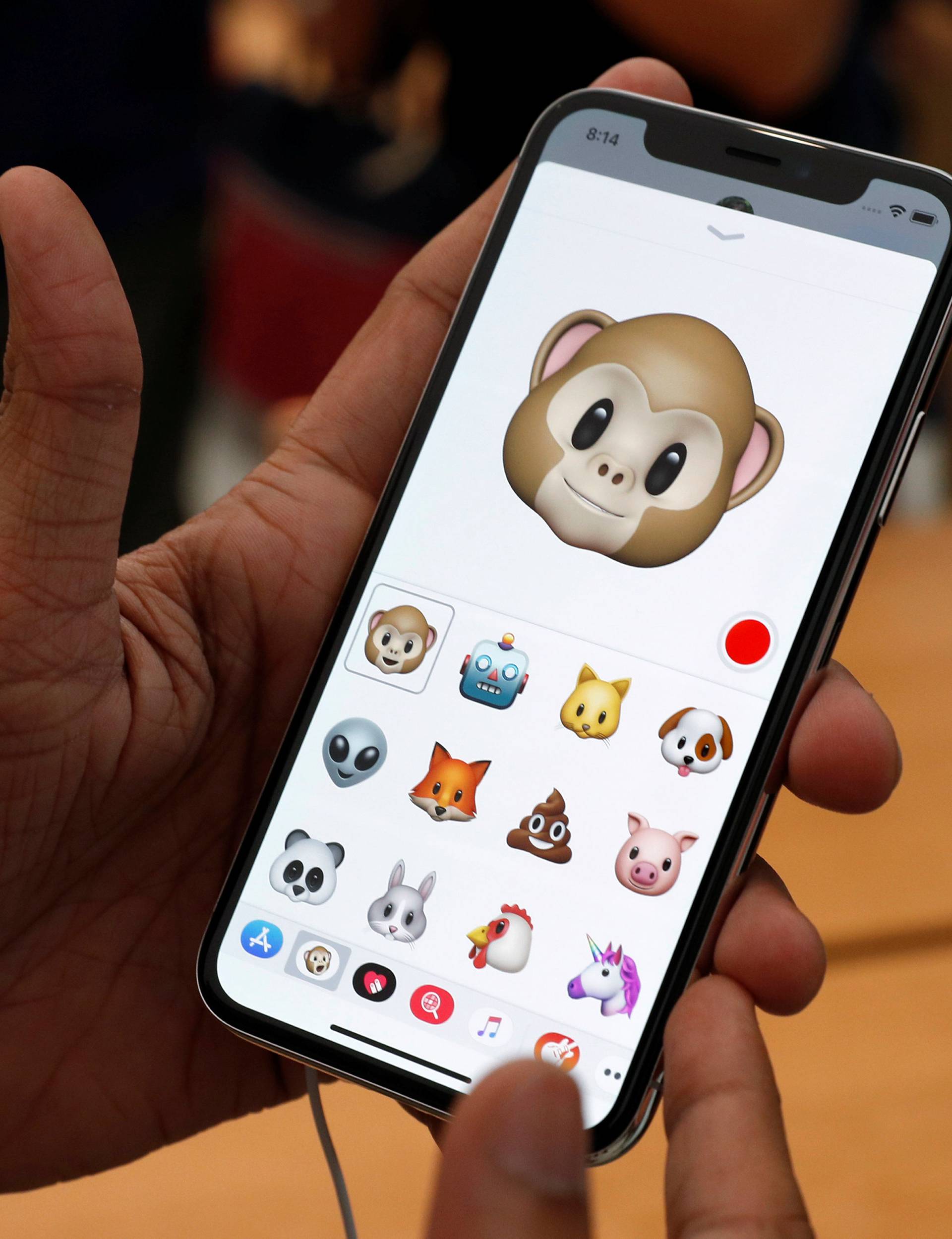 A man tries out the Animoji feature on the iPhone X during its launch at the Apple store in Singapore