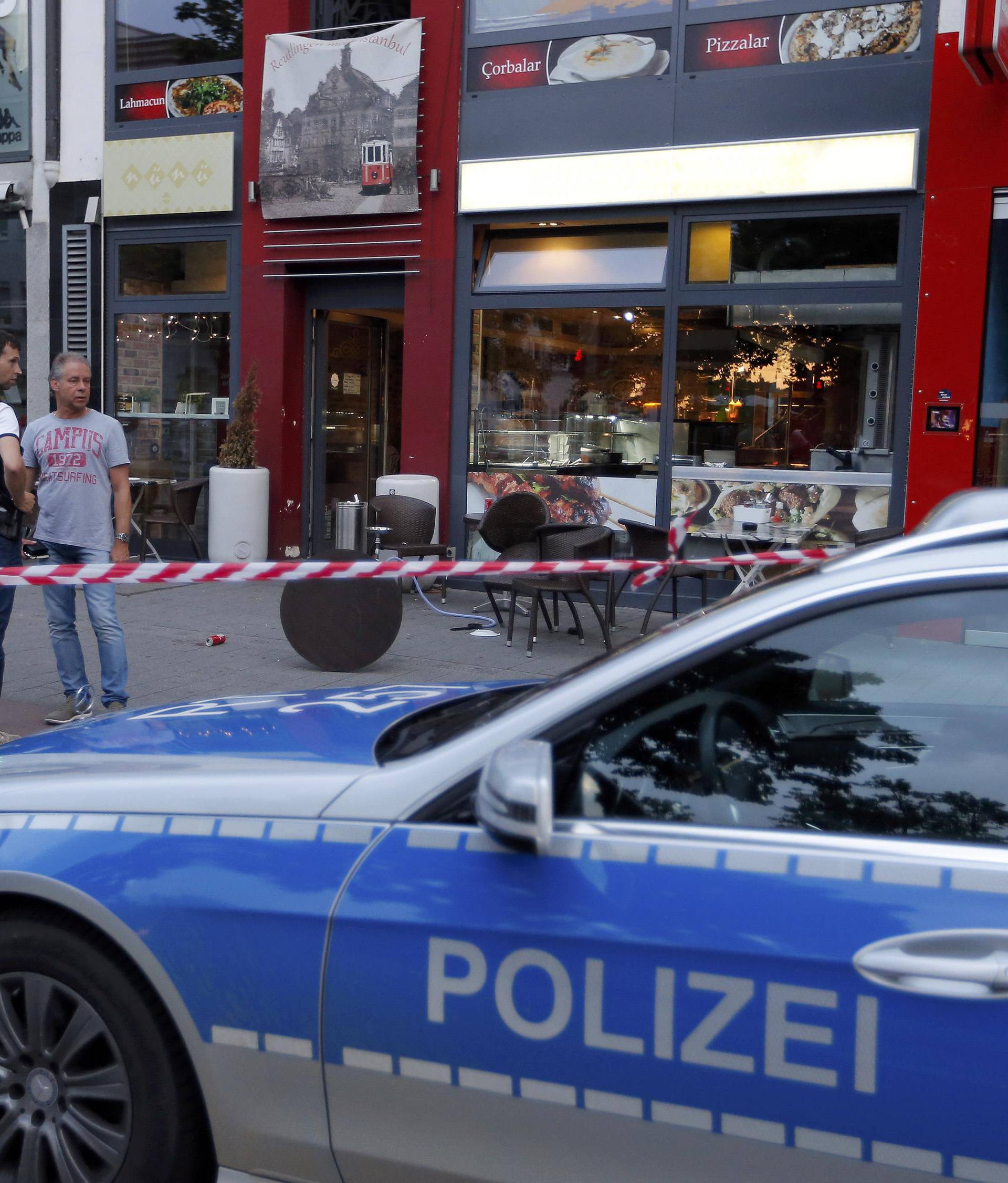 Police patrol outside where a 21-year-old Syrian refugee killed a woman with a machete in Reutlingen