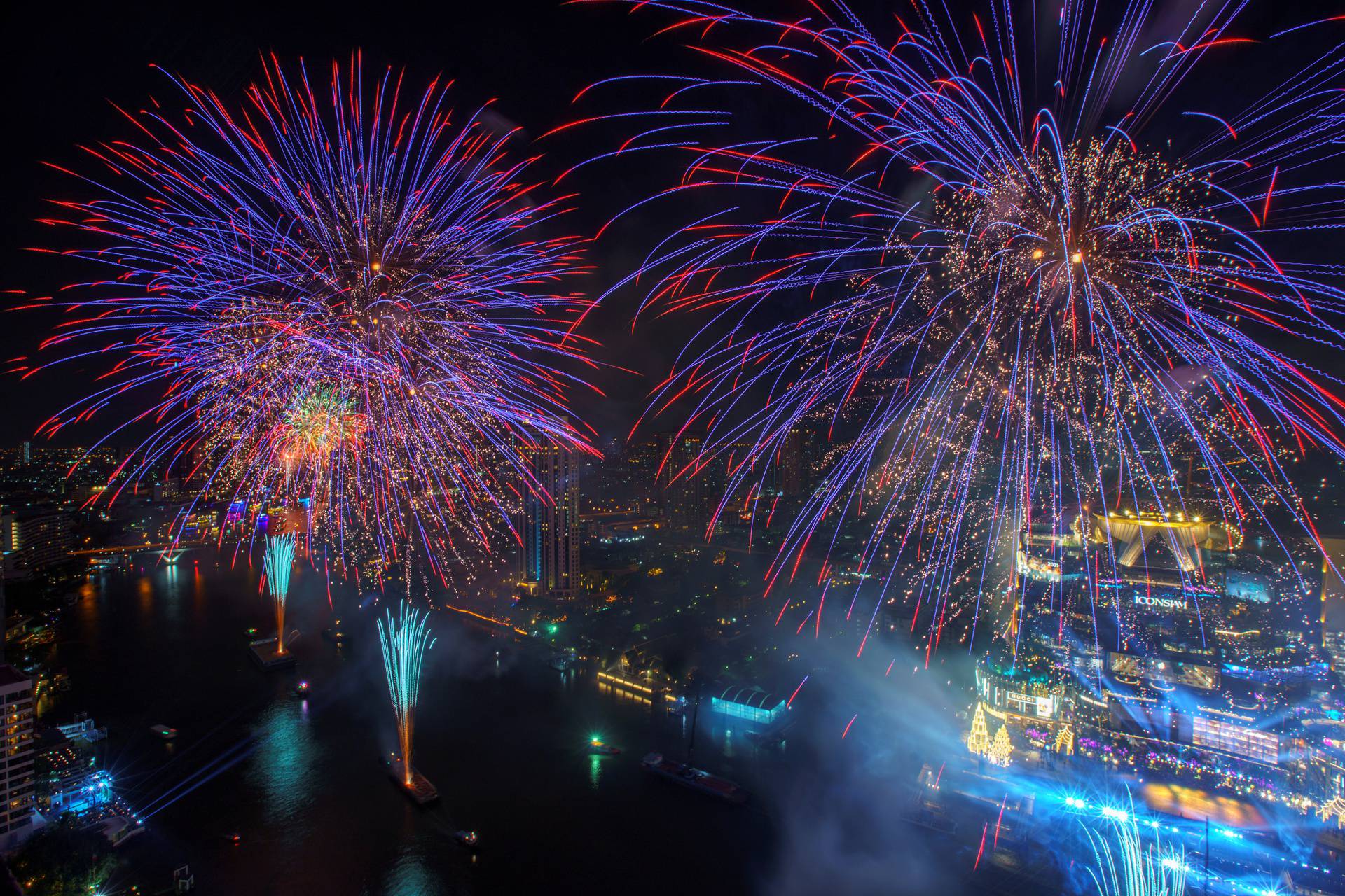 Fireworks explode over Chao Phraya River during the New Year celebrations amid the spread of the coronavirus disease (COVID-19) in Bangkok