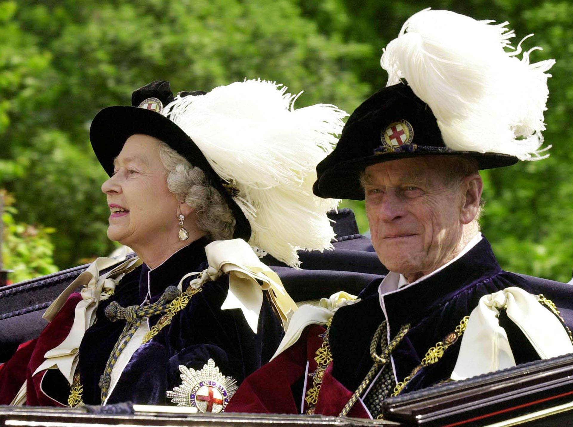 FILE PHOTO -  File photo of Britain's Queen Elizabeth II and Prince Phillip, the Duke of Edinburgh, riding in an open-topped carriage to Windsor Castle