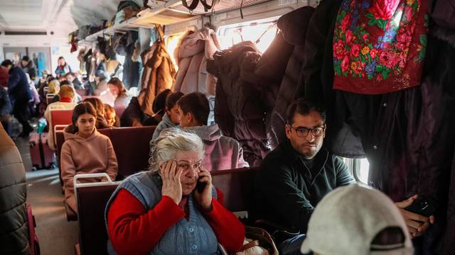 People are seen standing and sitting in an evacuation train from Kyiv to Lviv, at Kyiv central train station, in Kyiv