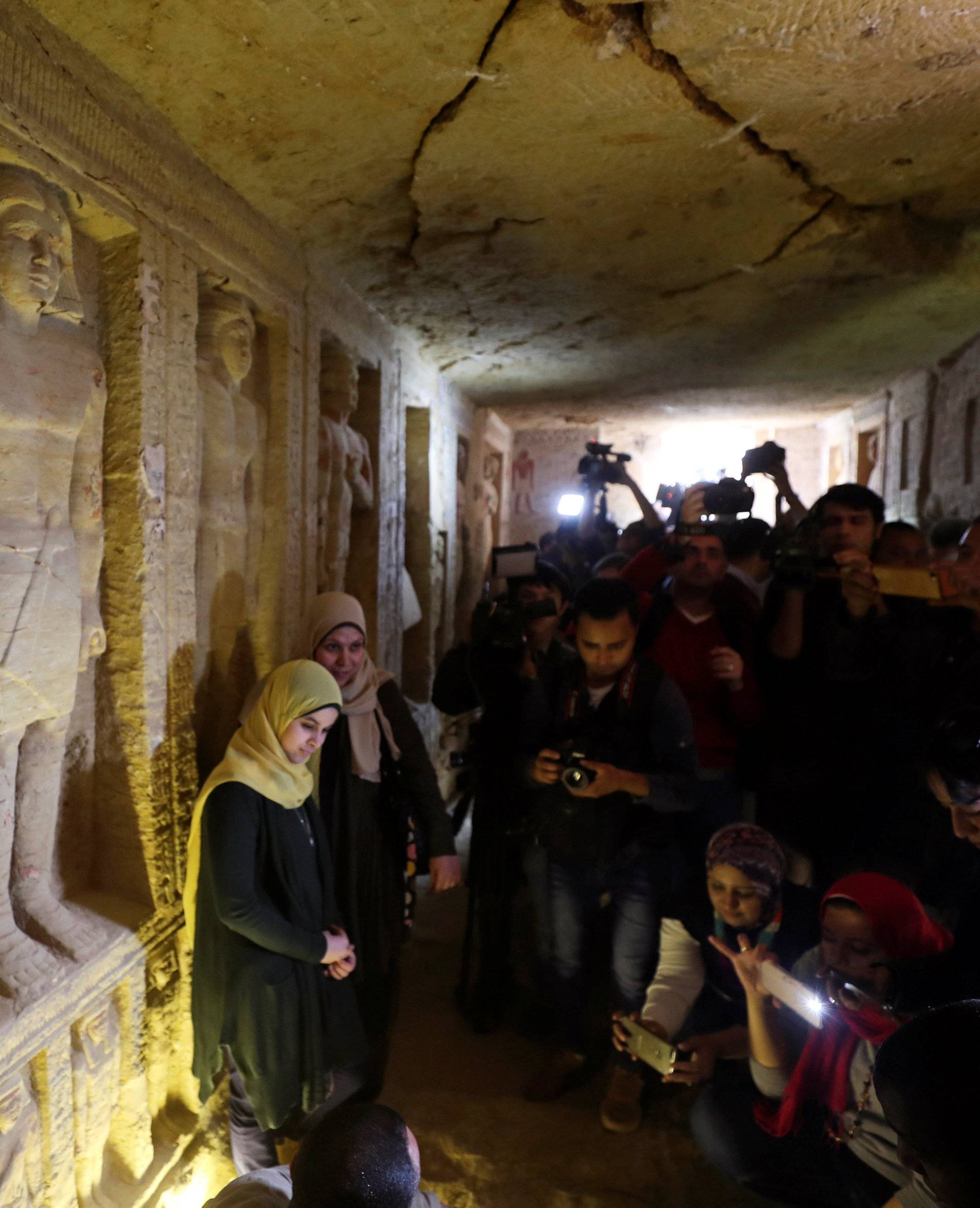 Journalists take photos inside the newly-discovered tomb of 'Wahtye', which dates from the rule of King Neferirkare Kakai, at the Saqqara area near its necropolis, in Giza