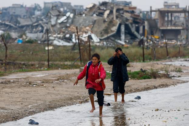 Displaced Palestinians shelter in a tent camp, on a rainy day in Nuseirat